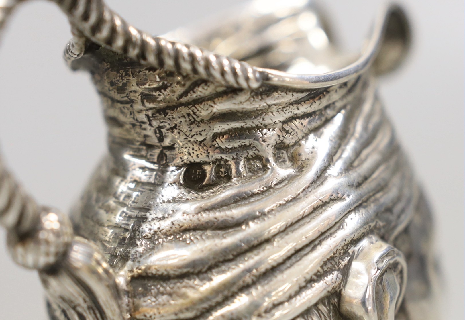 An Edwardian novelty silver 'character' cream jug, Williams Ltd, Birmingham, 1905, 93mm, 100 grams.